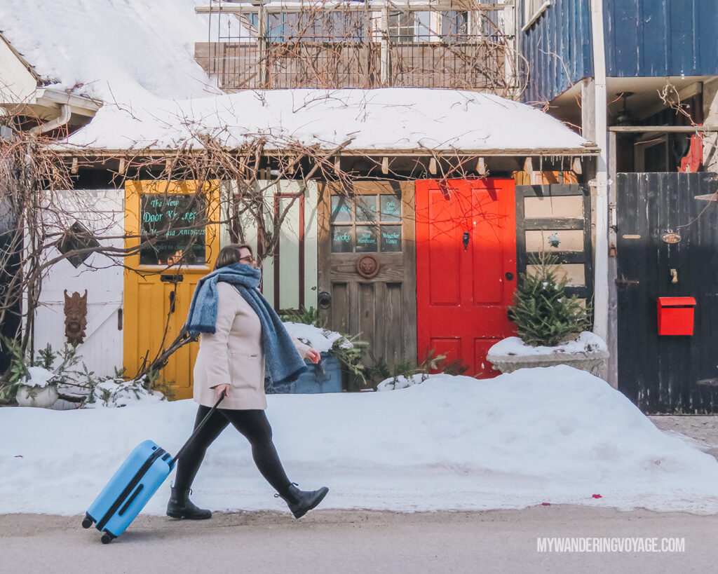 woman walking with CHESTER luggage outside in winter | CHESTER luggage review for best carry on luggage | My Wandering Voyage Travel Blog